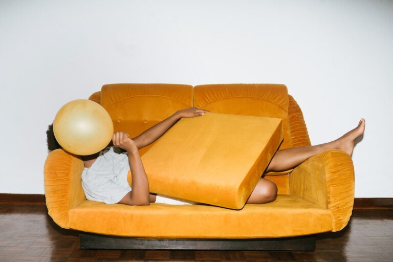 Photo by RF._.studio: https://www.pexels.com/photo/person-lying-on-orange-sofa-3621210/